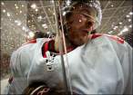Romano Lemm is slammed into the side during Switzerland's 2-2 draw with Germany in Group A of the men's ice hockey.jpg